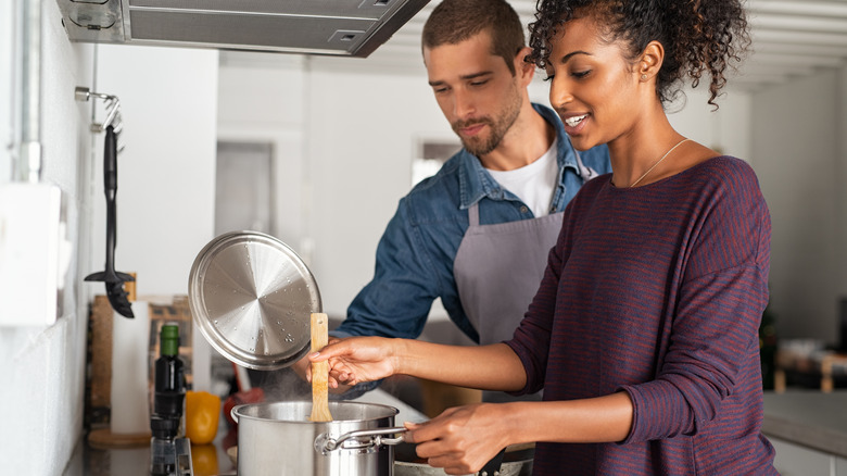 Friends cooking soup on stove