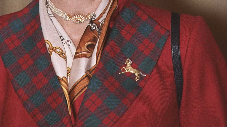 Red jacket with a gold horse brooch