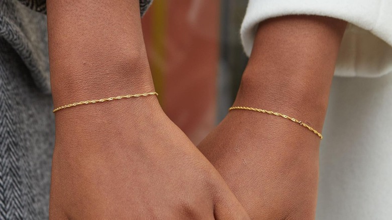 Women wearing permanent bracelets