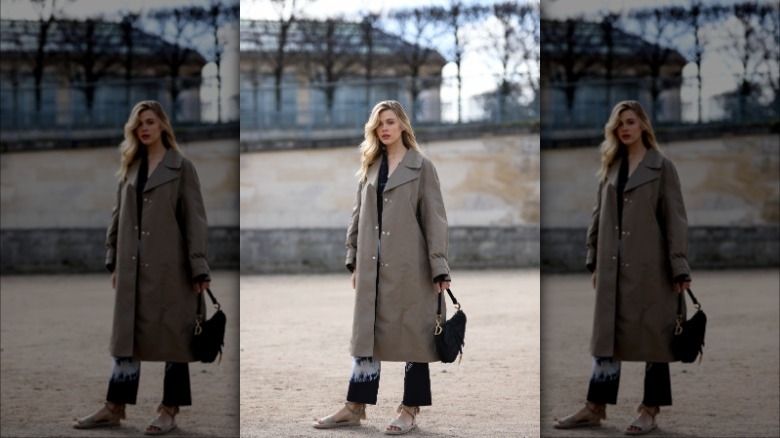 Woman wearing trench coat, espadrille sandals