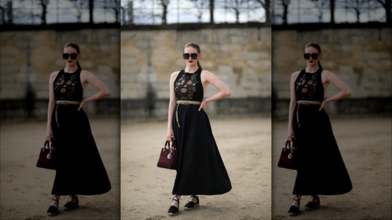 Woman wearing black dress, flat espadrilles