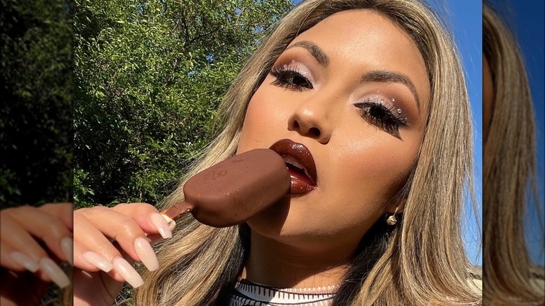 Woman with espresso makeup eating ice cream
