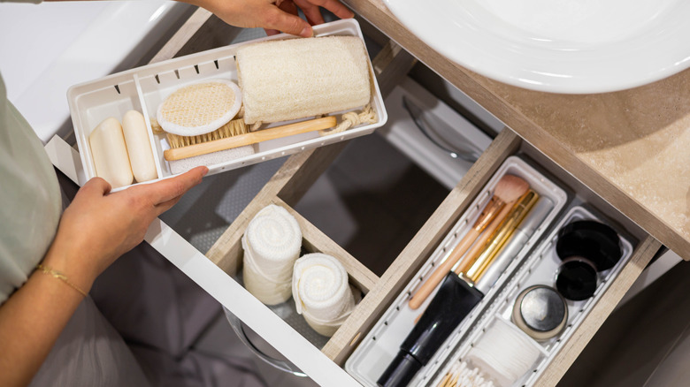 Woman organizing bathroom drawers