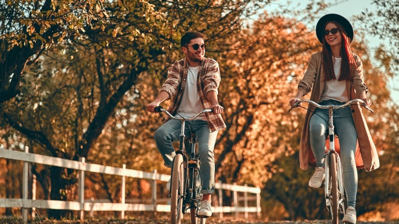 Couple riding bikes in forest