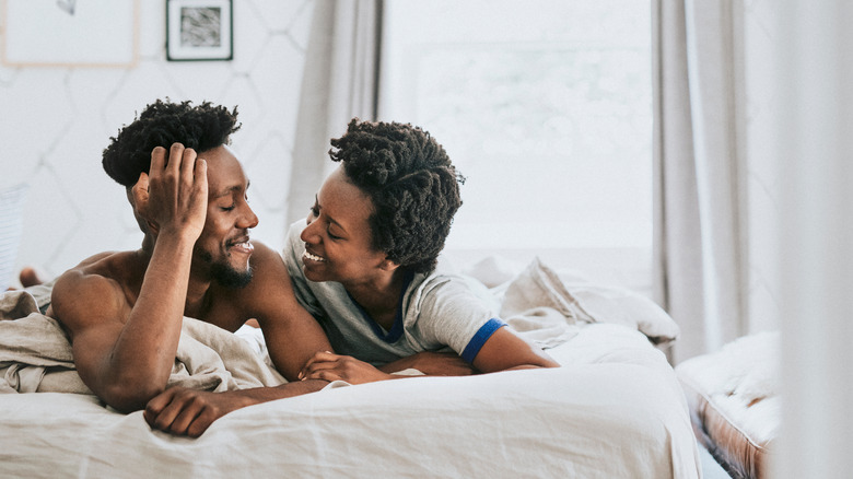 smiling couple in bed