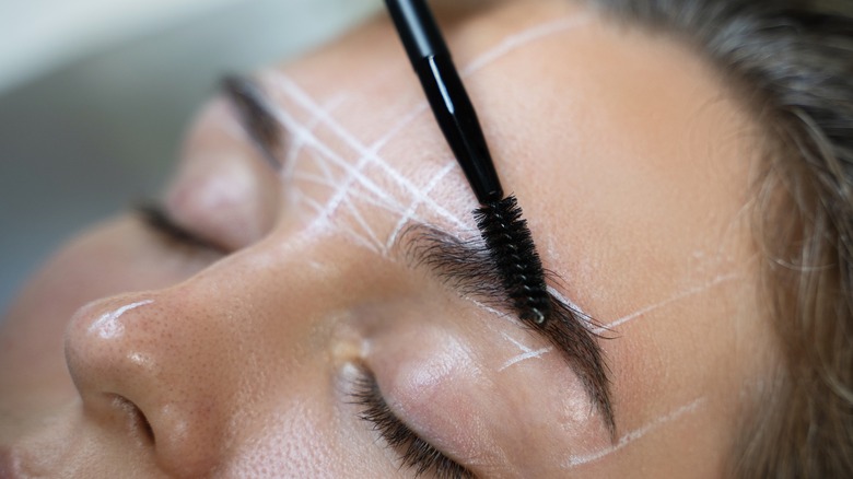 woman mapping out brows