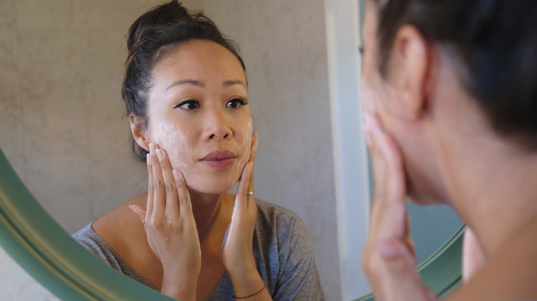 A woman washing her face