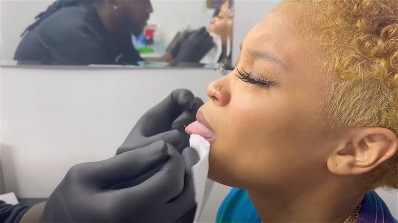 getting snake eyes tongue piercing