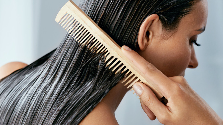 A woman brushing her conditioned hair