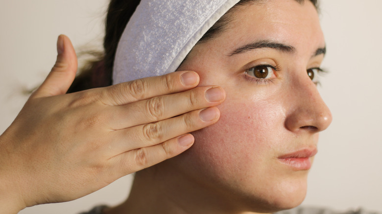 Woman inspecting her skin