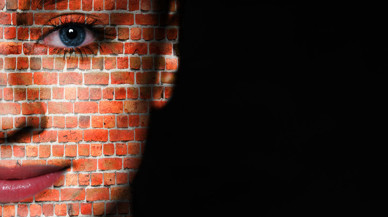 Woman's skin depicted as a brick wall