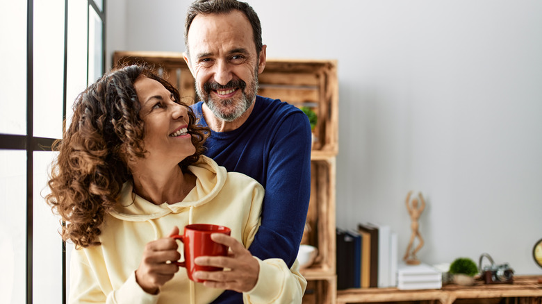 couple hugging while enjoying coffee