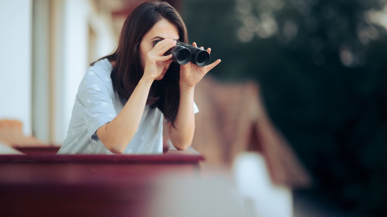 woman stalking with binoculars