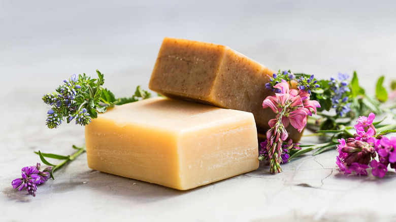 Two bars of soap surrounded by flowers