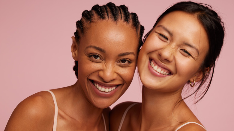 Two smiling women with glowing skin