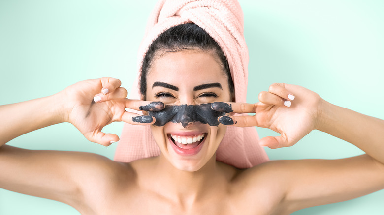 Woman applying a face mask