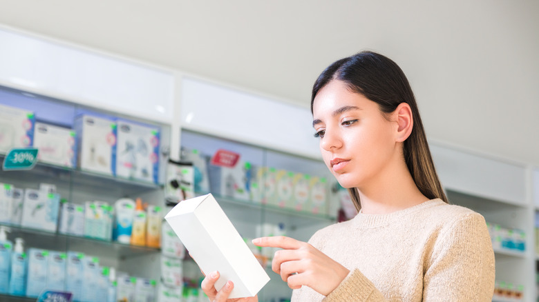 Woman reading product labels