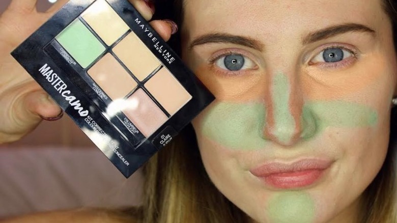 Woman with color correcting concealer on her face 