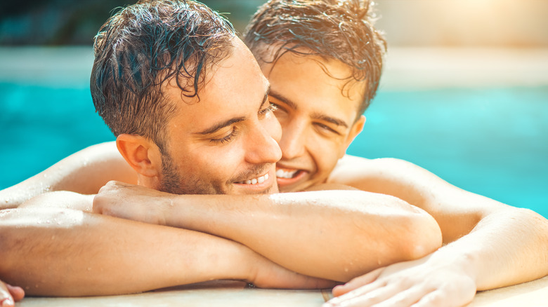 Couple cuddling in the pool 