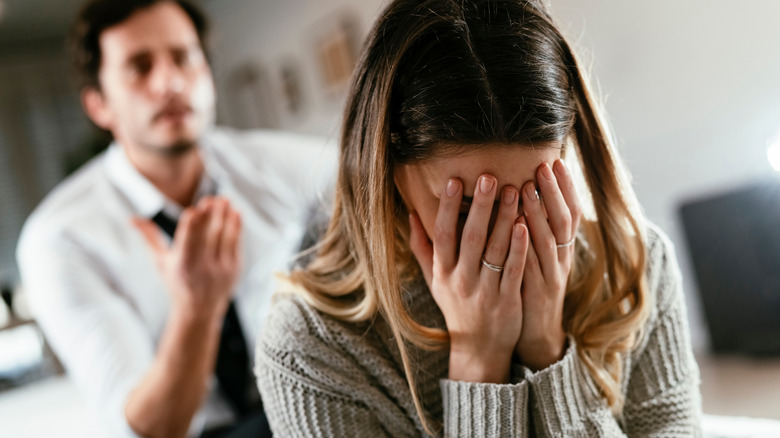 Sad woman with hands on face