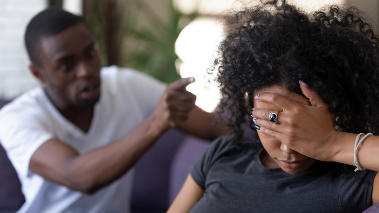 Couple arguing on a couch