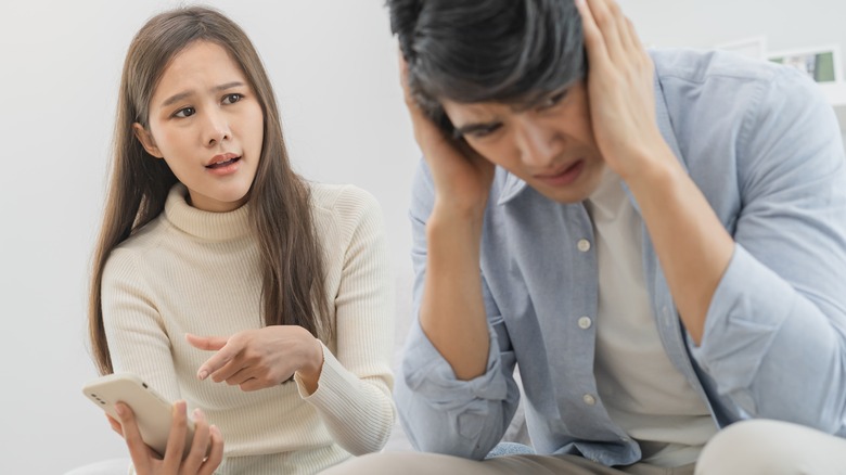 Couple in an argument over a phone