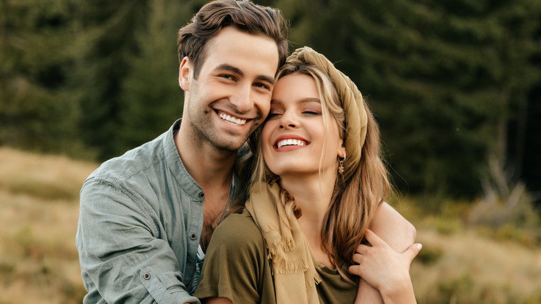 Couple holding each other outdoors