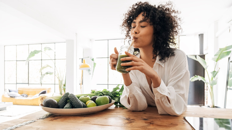 Woman enjoying a green juice 