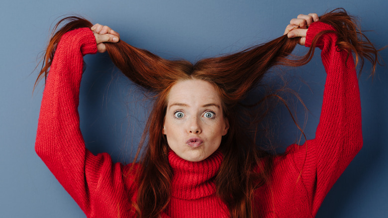Woman with red hair and a red sweater 