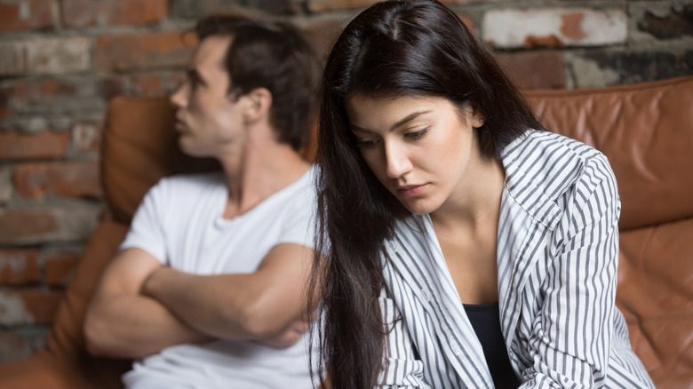 Couple breaking up on a couch 