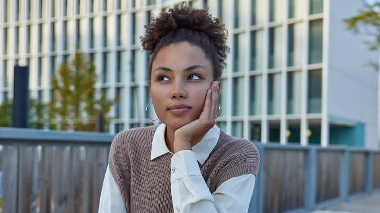 Woman looking away thinking 