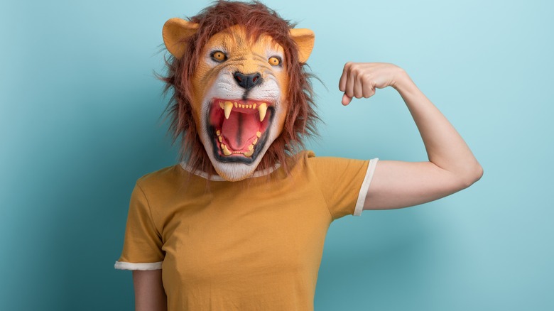 woman wearing lion mask