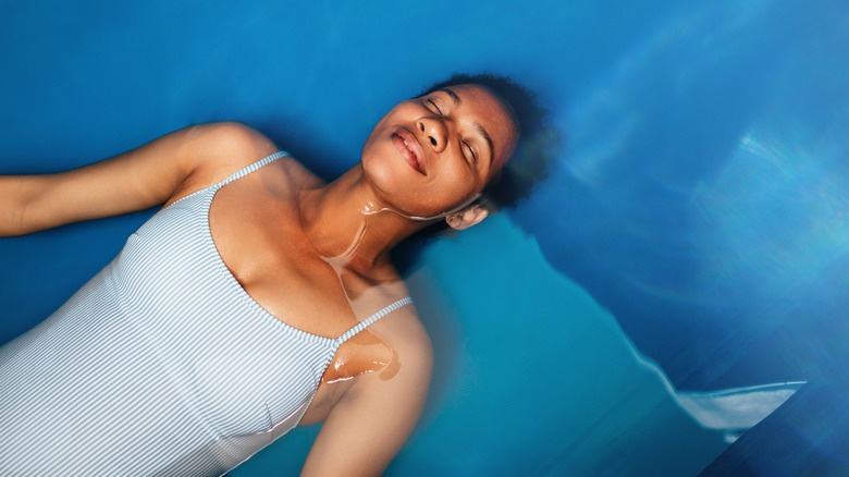 Woman floating inside float tank