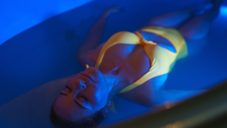 Woman floating inside float tank 