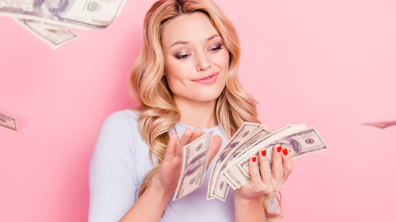 Blond woman holding money