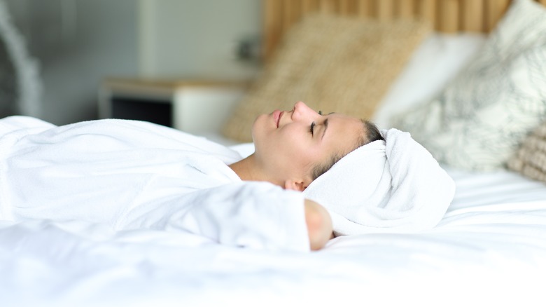 woman sleeping with hair in towel