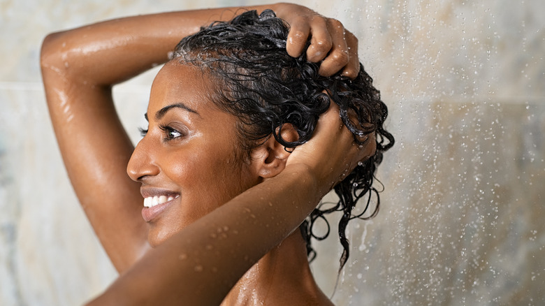 woman washing curly hair