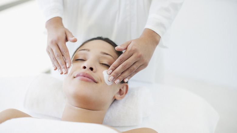 A woman getting face treatment