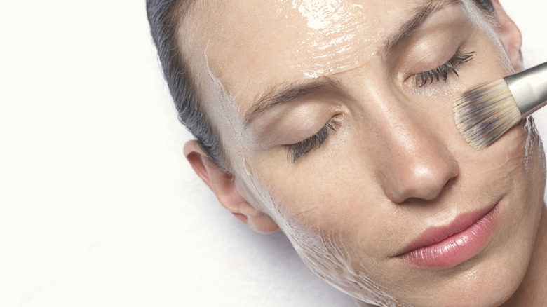 Woman applying a face mask