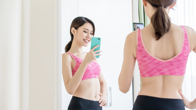 woman taking selfie in mirror