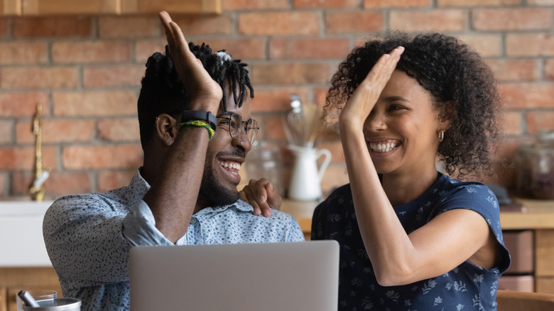 Couple high-fiving 