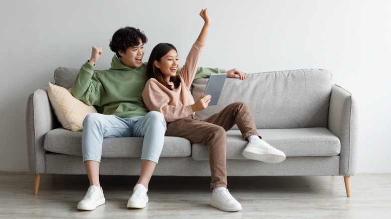 Happy couple sitting on couch 