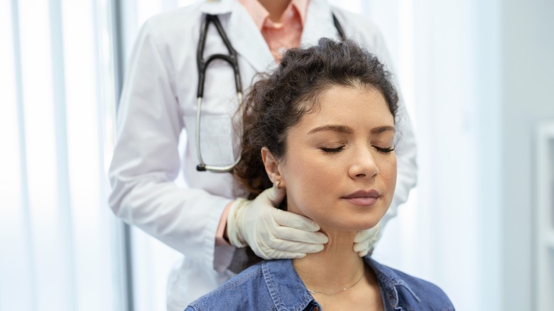 Woman getting her neck examined