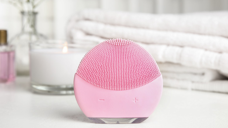 Pink facial cleansing brush