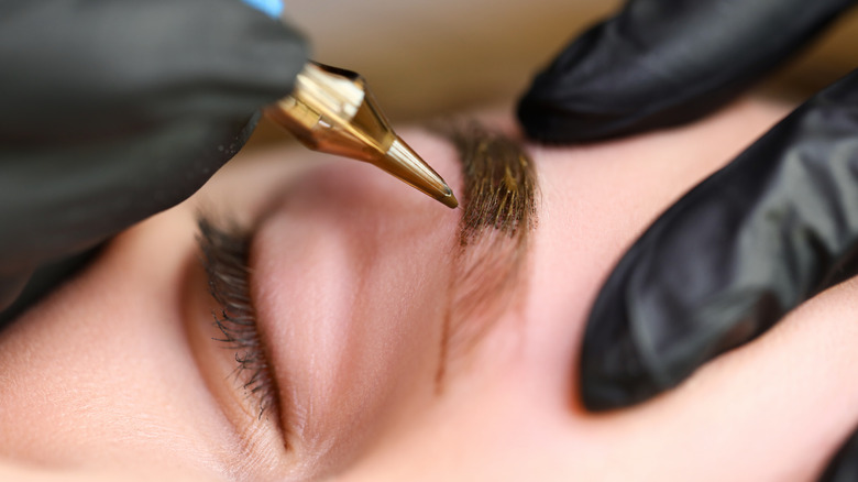 Woman receiving microblading treatment