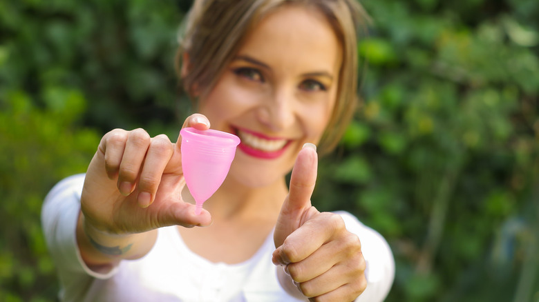 woman thumbs up menstrual cup
