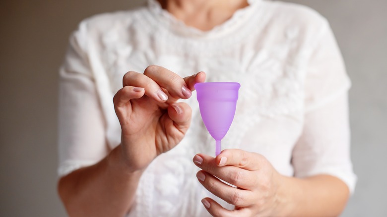 woman holding menstrual cup