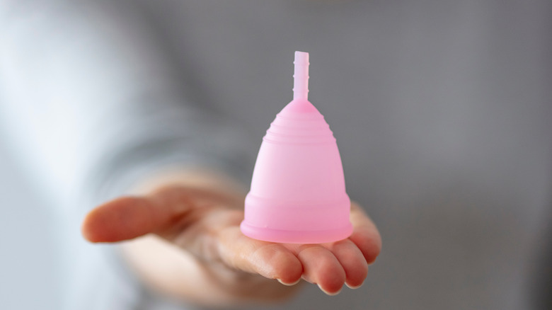 woman holding menstrual cup