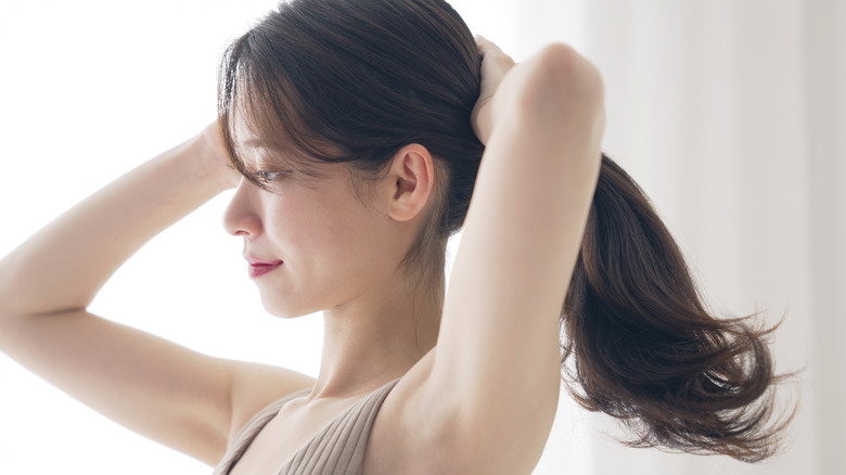 Woman touching her hair