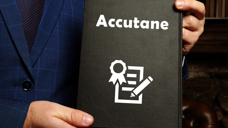 A person holding Accutane sign